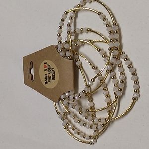 7 semi stretch bracelets Women's. Gold & Pearl colored beads w gold spacer.